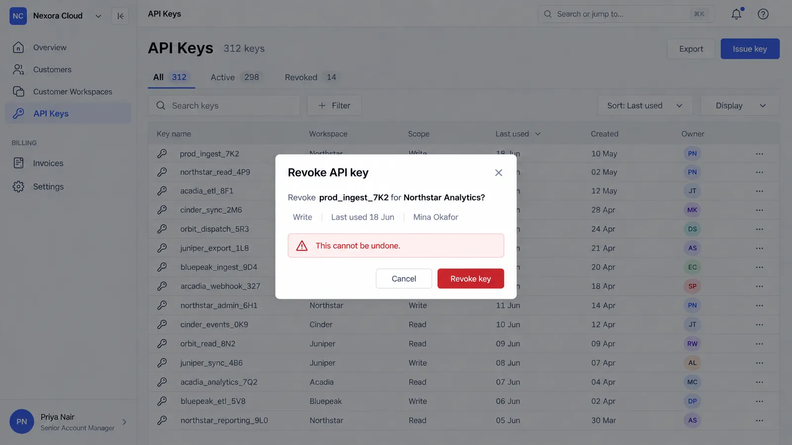 Nexora Console Revoke API Key screen: a confirmation dialog to revoke prod_ingest_7K2 over the dimmed API keys list